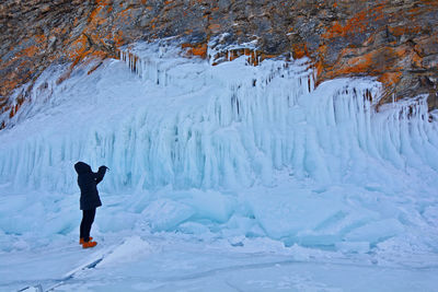 Tourists take picrure the beauty of an ice cave on lake baikal, russia