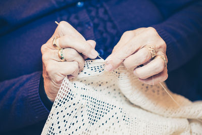 Midsection of woman knitting textile