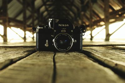 Close-up of camera on wooden table