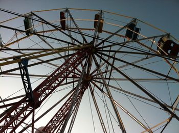 Low angle view of ferris wheel against sky