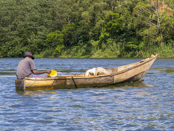 Man on boat sailing in river