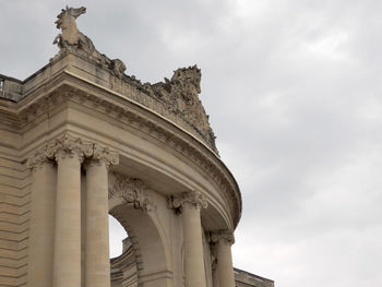 Low angle view of historical building against cloudy sky