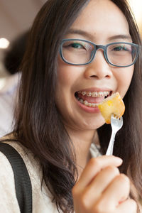 Portrait of young woman having food