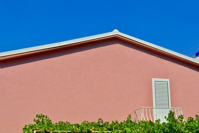 Low angle view of house against clear blue sky