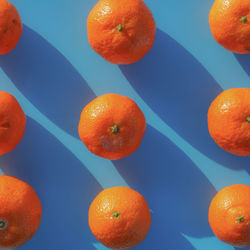 Directly above shot of orange fruit against blue background