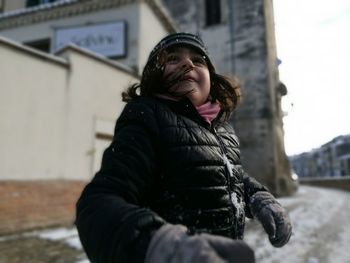 Young woman smiling in snow