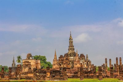 Old temple building against cloudy sky