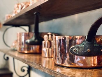 Close-up of kitchen utensils on shelf