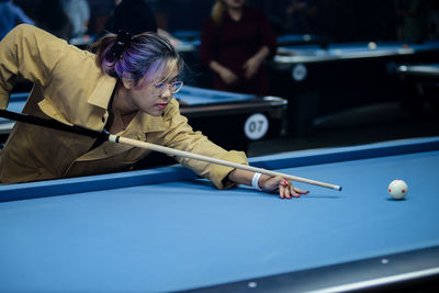 Close-up of boy playing pool