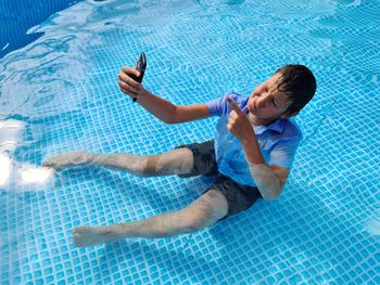 High angle view of woman swimming in pool