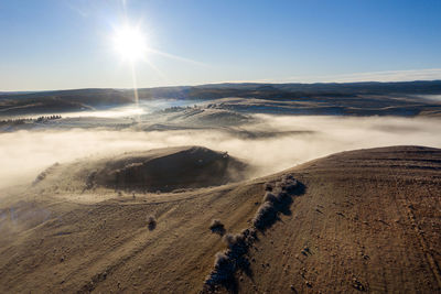 Flying over hills in mystic foggy winter morning. aerial view by drone