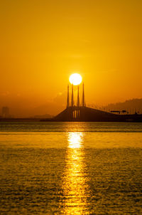 Scenic view of sea against orange sky