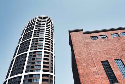 Low angle view of modern buildings against clear sky