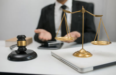 Close-up of a person holding camera over white background
