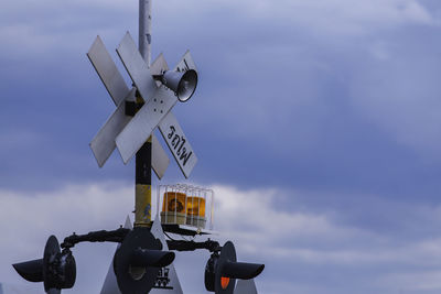 Low angle view of signal against sky