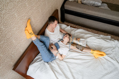 High angle view of young woman sleeping on bed at home