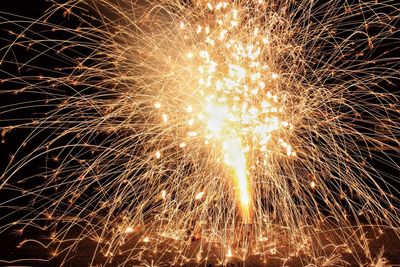 Low angle view of firework display at night