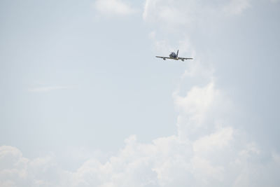 Low angle view of airplane flying in sky