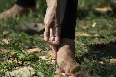 Low section of man exercising on field