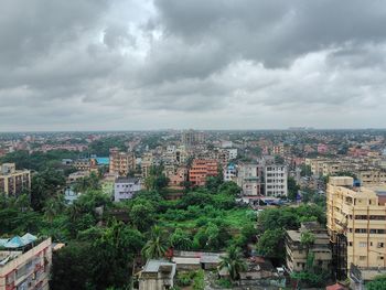 Buildings against cloudy sky