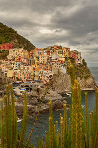 Townscape by sea against sky in town