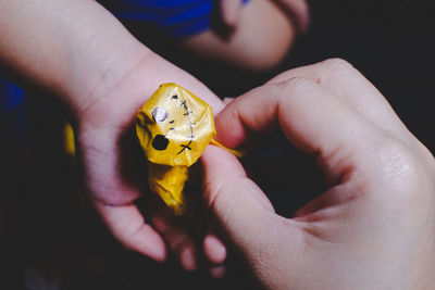 Close-up of person holding yellow leaf