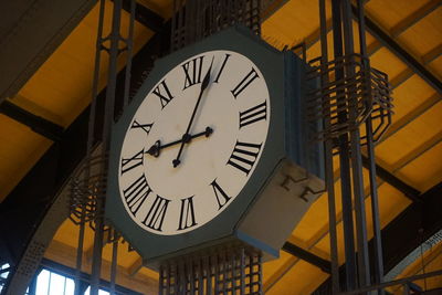 Low angle view of clock on ceiling at railroad station hamburg 