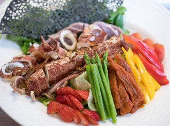 High angle view of vegetables and fruits in plate