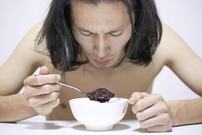 Close-up of young man eating food