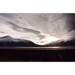 Scenic view of mountains against cloudy sky