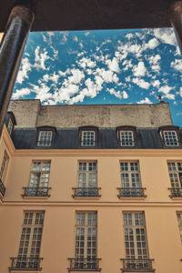 Low angle view of buildings against blue sky