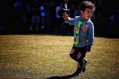 Full length of boy standing on field