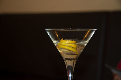 Close-up of beer glass against black background