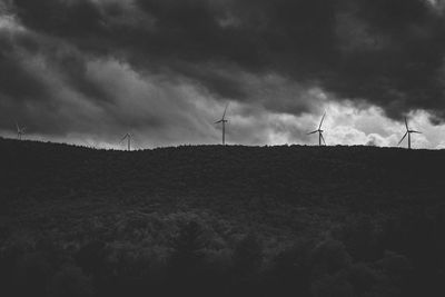 Traditional windmill on field against sky