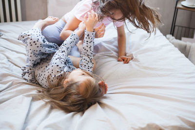 High angle view of girl lying on bed at home