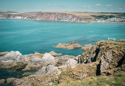 High angle view of cliffs by sea against sky