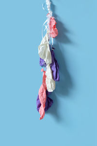 High angle view of paper hanging against blue background