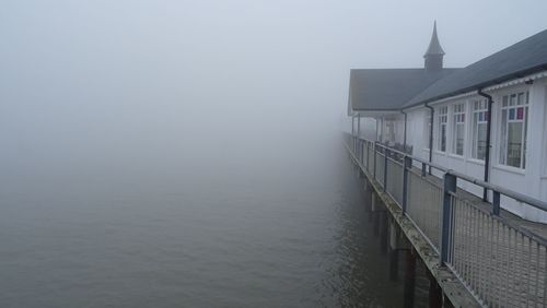 Building by sea against sky