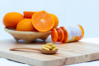 Close-up of orange fruits on cutting board