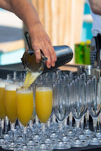 Close-up of man pouring wine in glass bottle