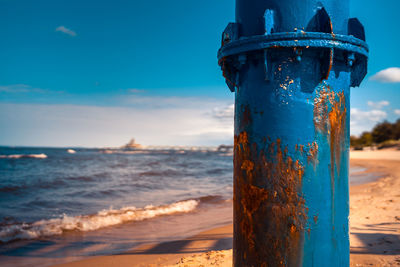 Close-up of blue sea against sky during winter