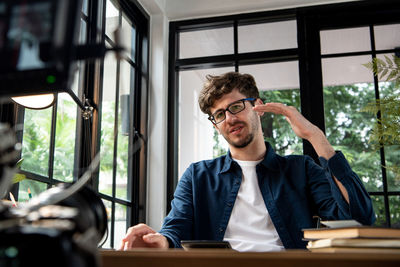 Portrait of man vlogging at office