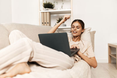 Young woman using laptop at home