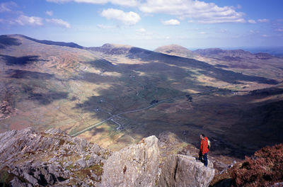 Rear view of man standing on hill