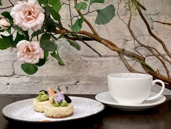 High angle view of cup and coffee served on table