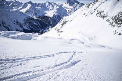 Scenic view of snow covered mountains against sky