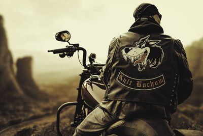 Rear view of man wearing hat against sky