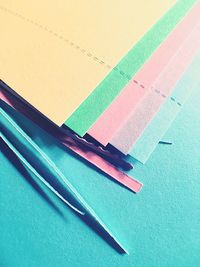 High angle view of multi colored papers on table