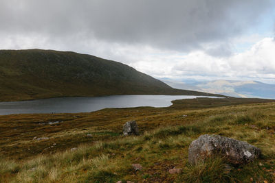 Scenic view of mountains against cloudy sky