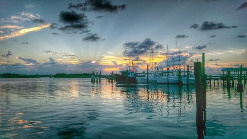 Reflection of clouds in sea at sunset